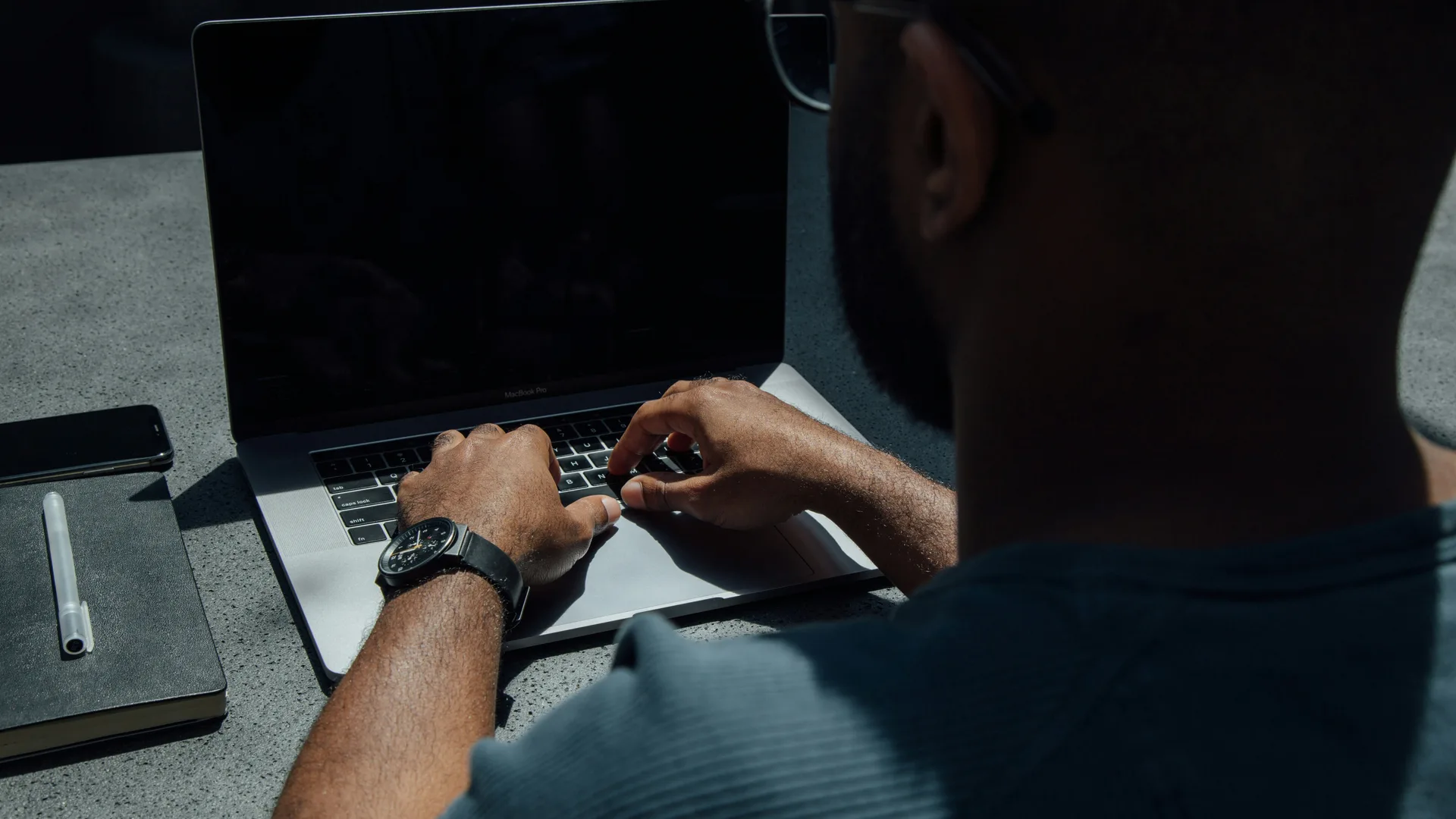 An owner working through the books on a laptop late in the evening