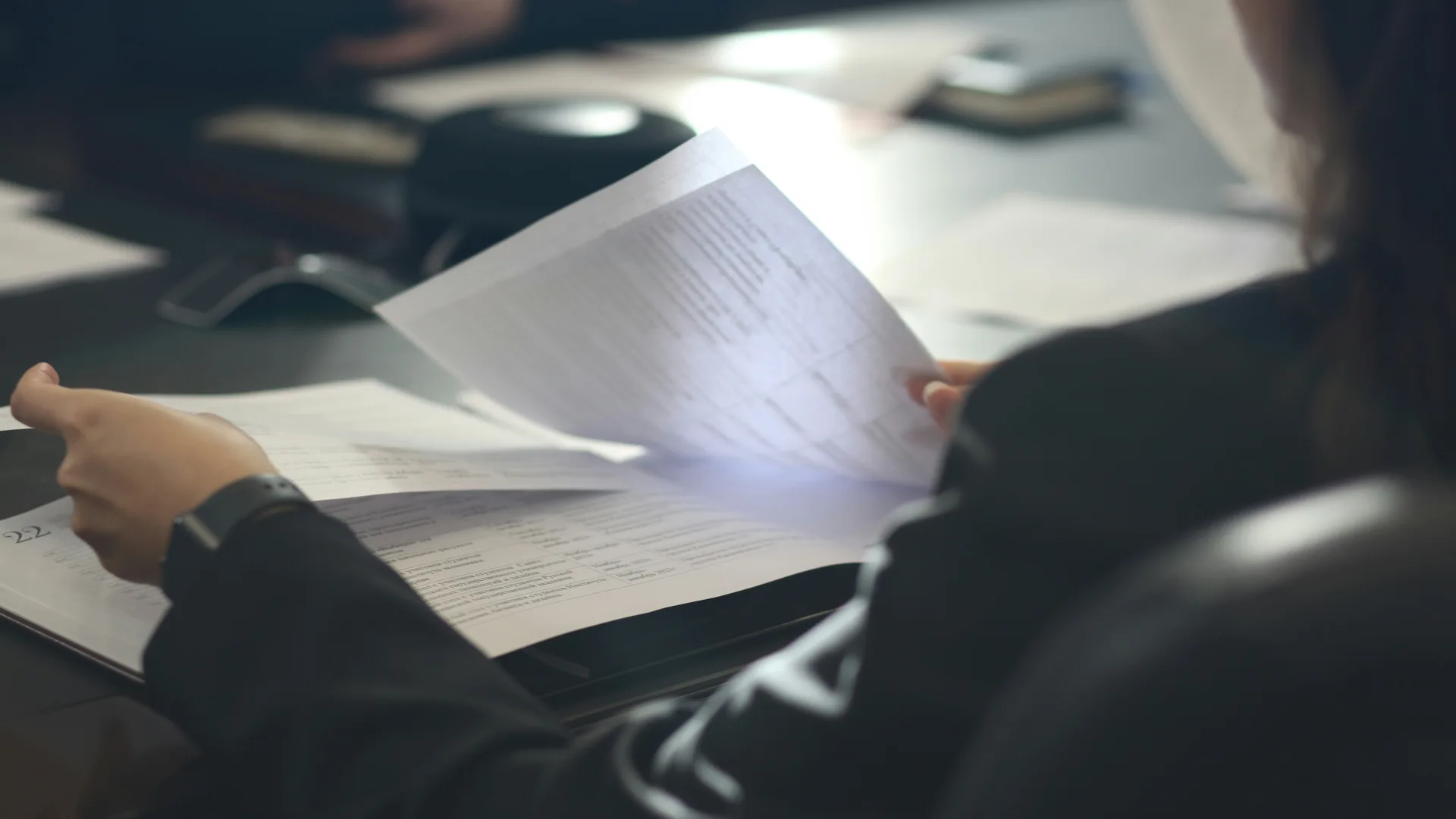 A supervisor reviewing printed workflow documents