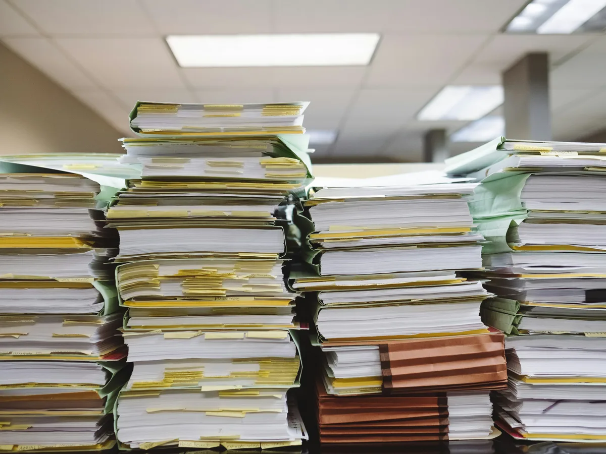 Stacks of certificate folders and renewal paperwork