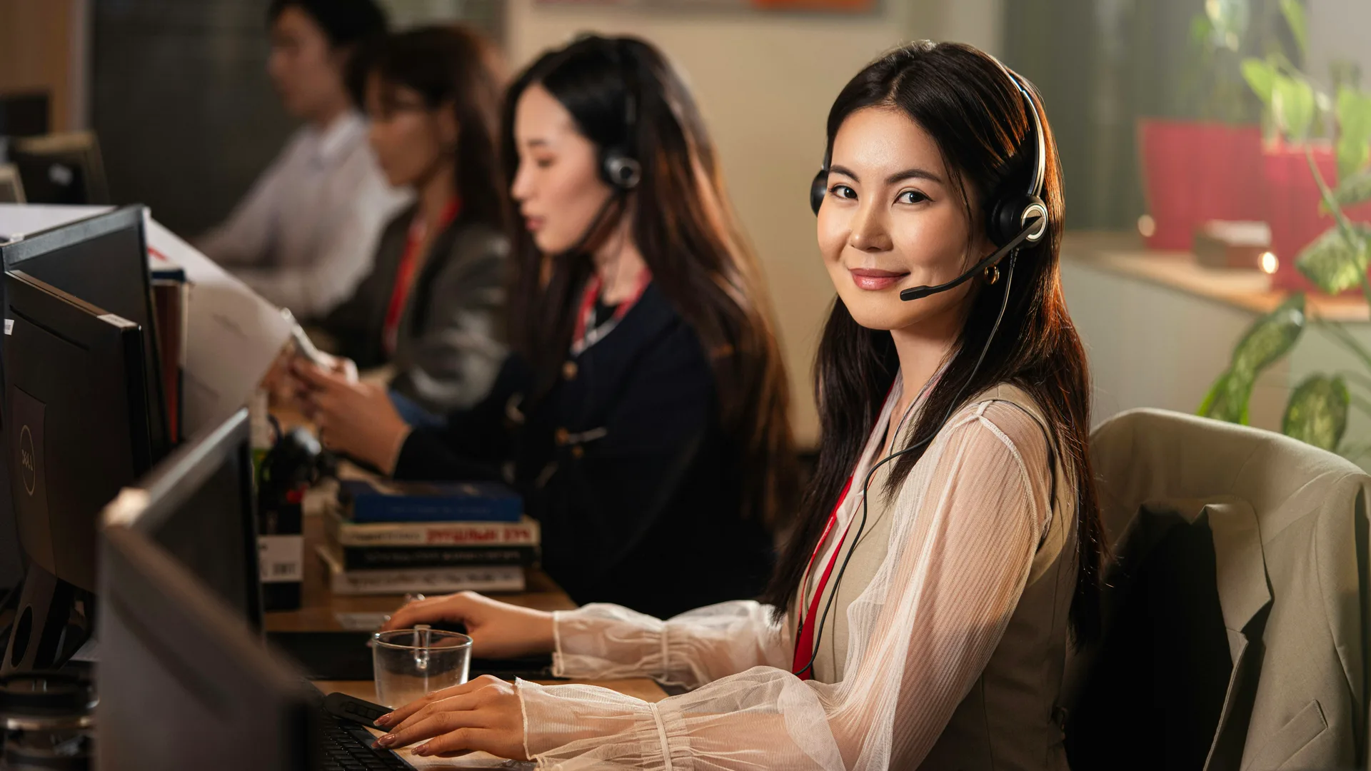 A desk team member wearing a headset, mid-call