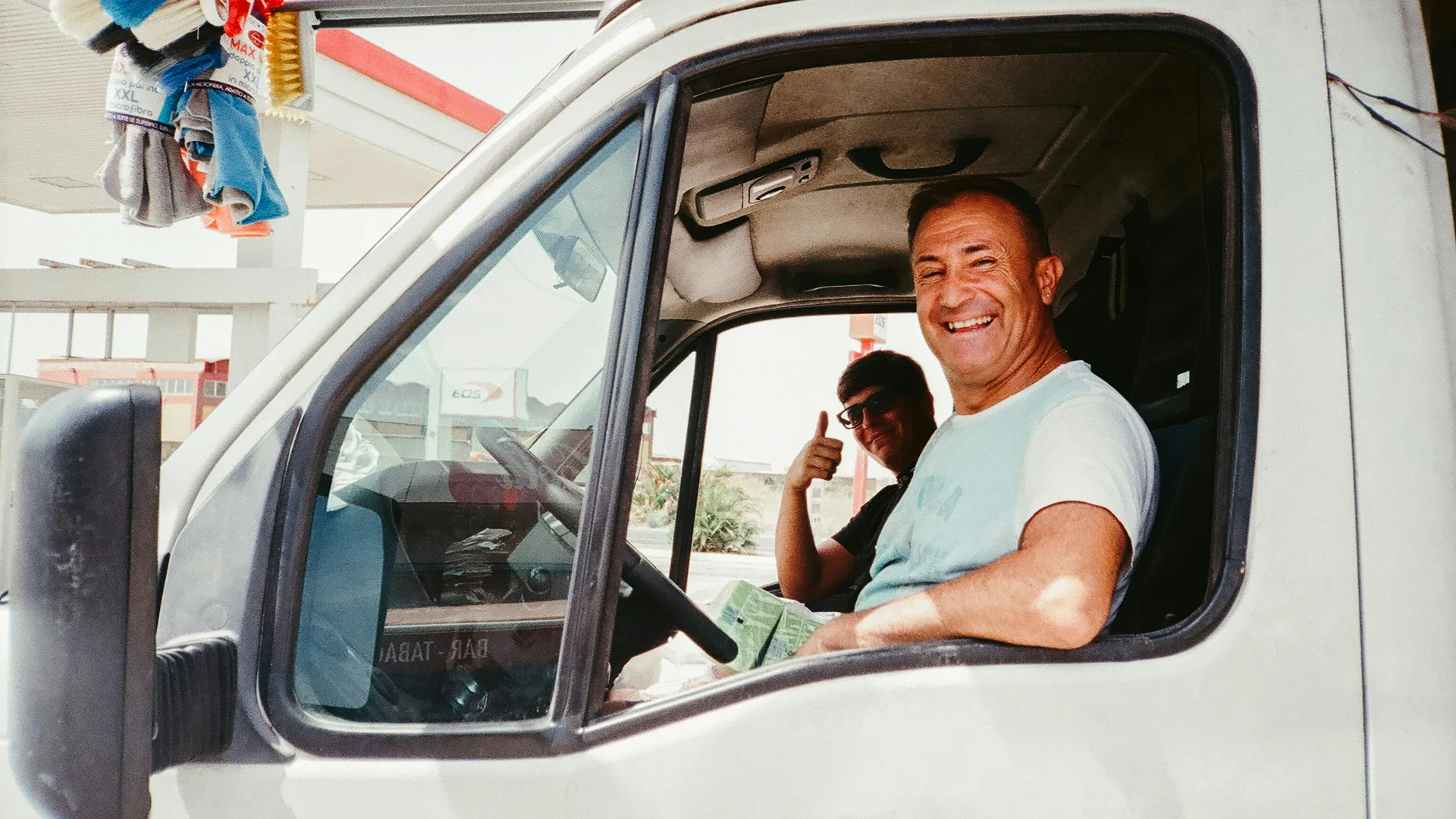 An owner checking his phone from the van cab between jobs