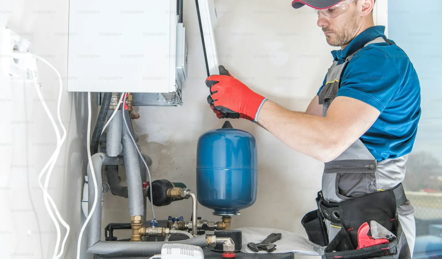 A heating engineer servicing a boiler